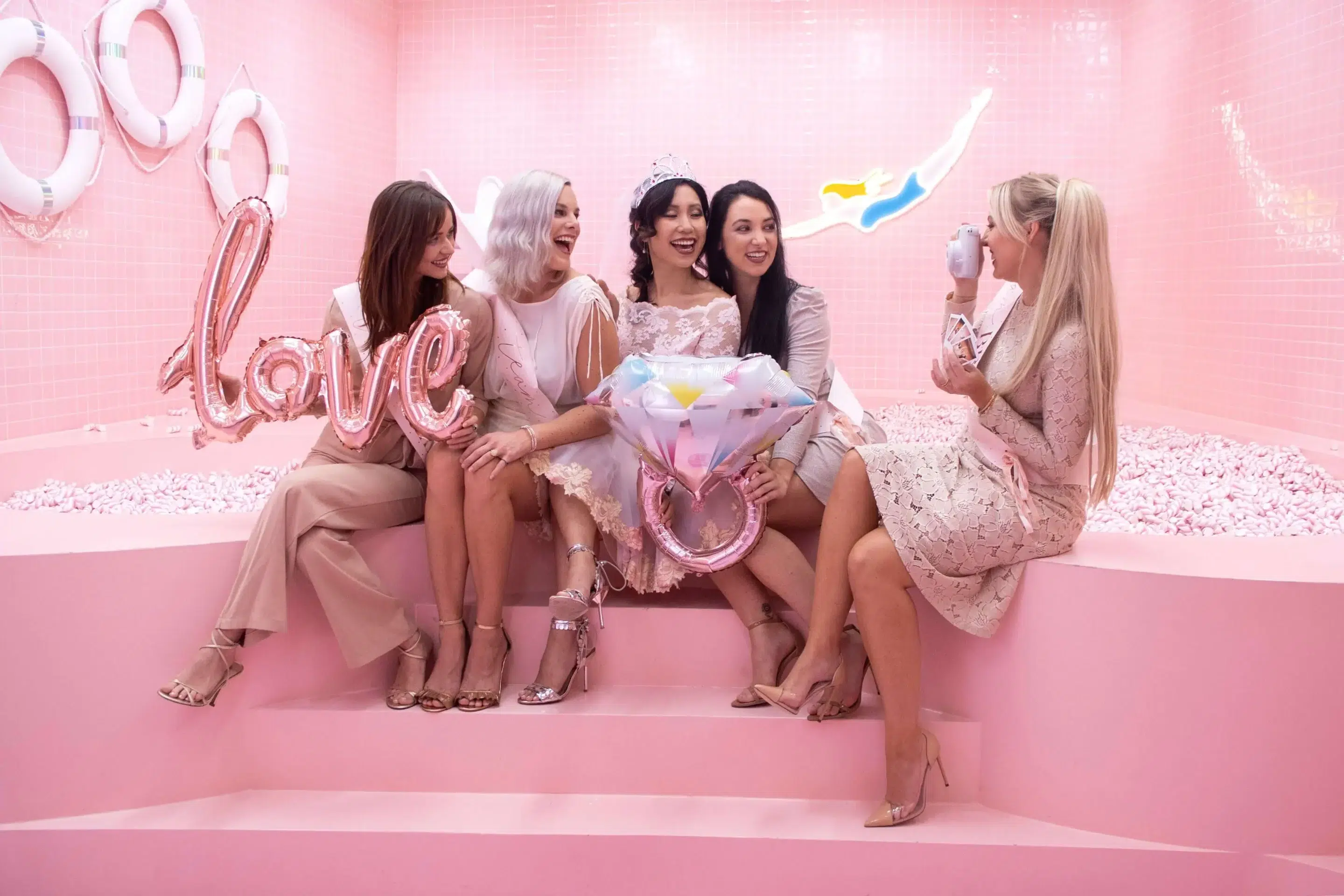 Group of girls sitting at the edge of a marshmallow pool